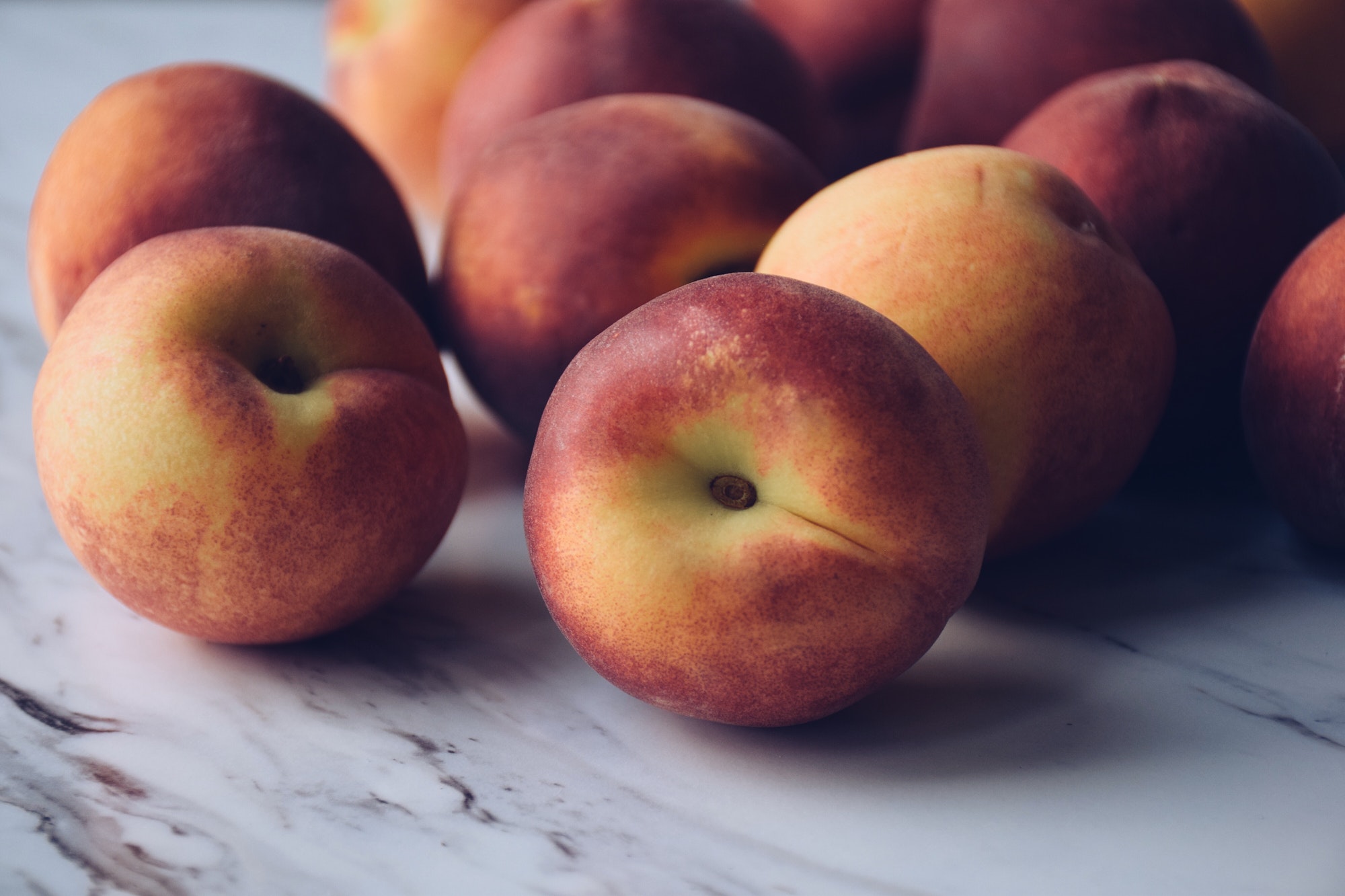 Fresh peaches on a marble countertop