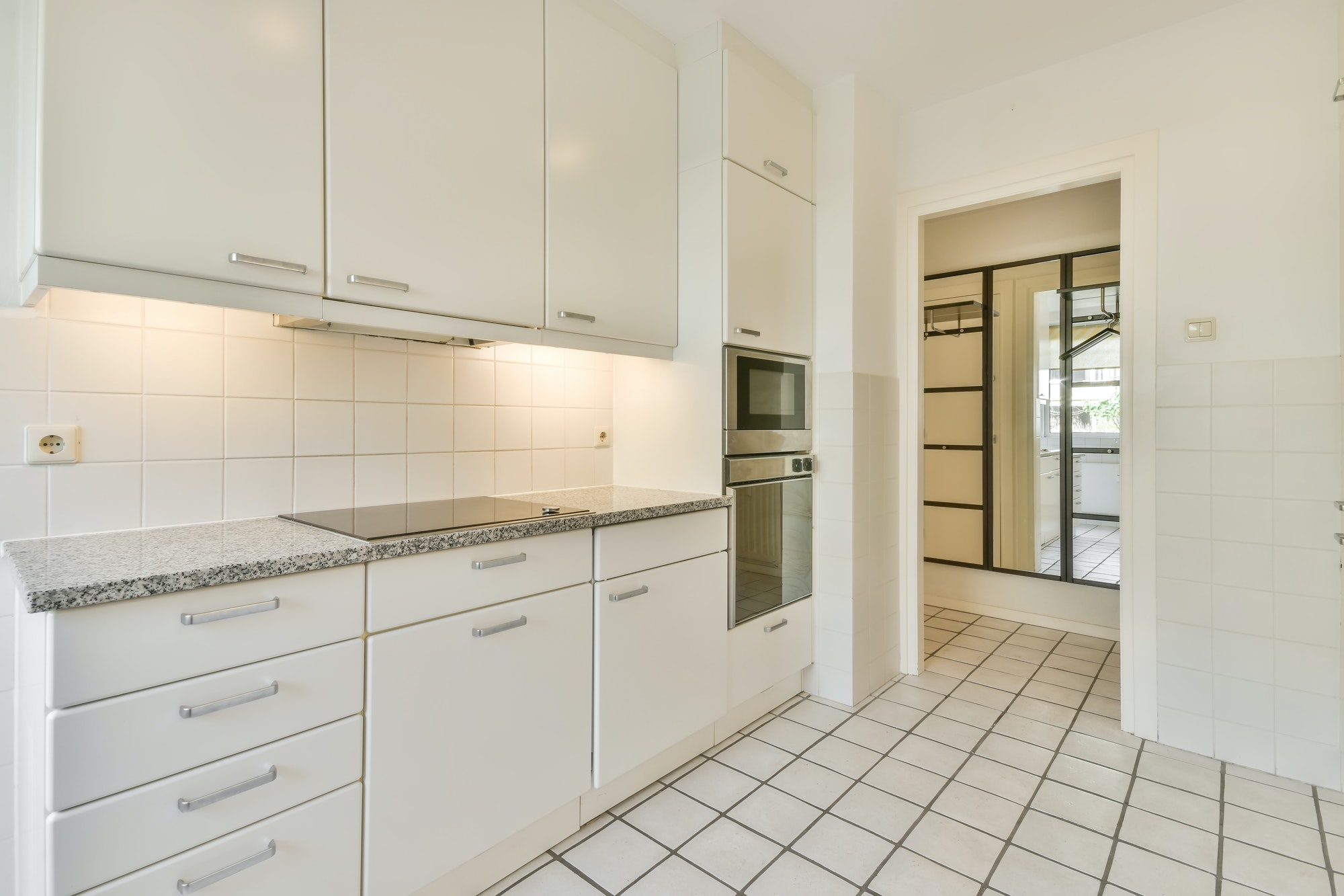 White tiled floor in light kitchen