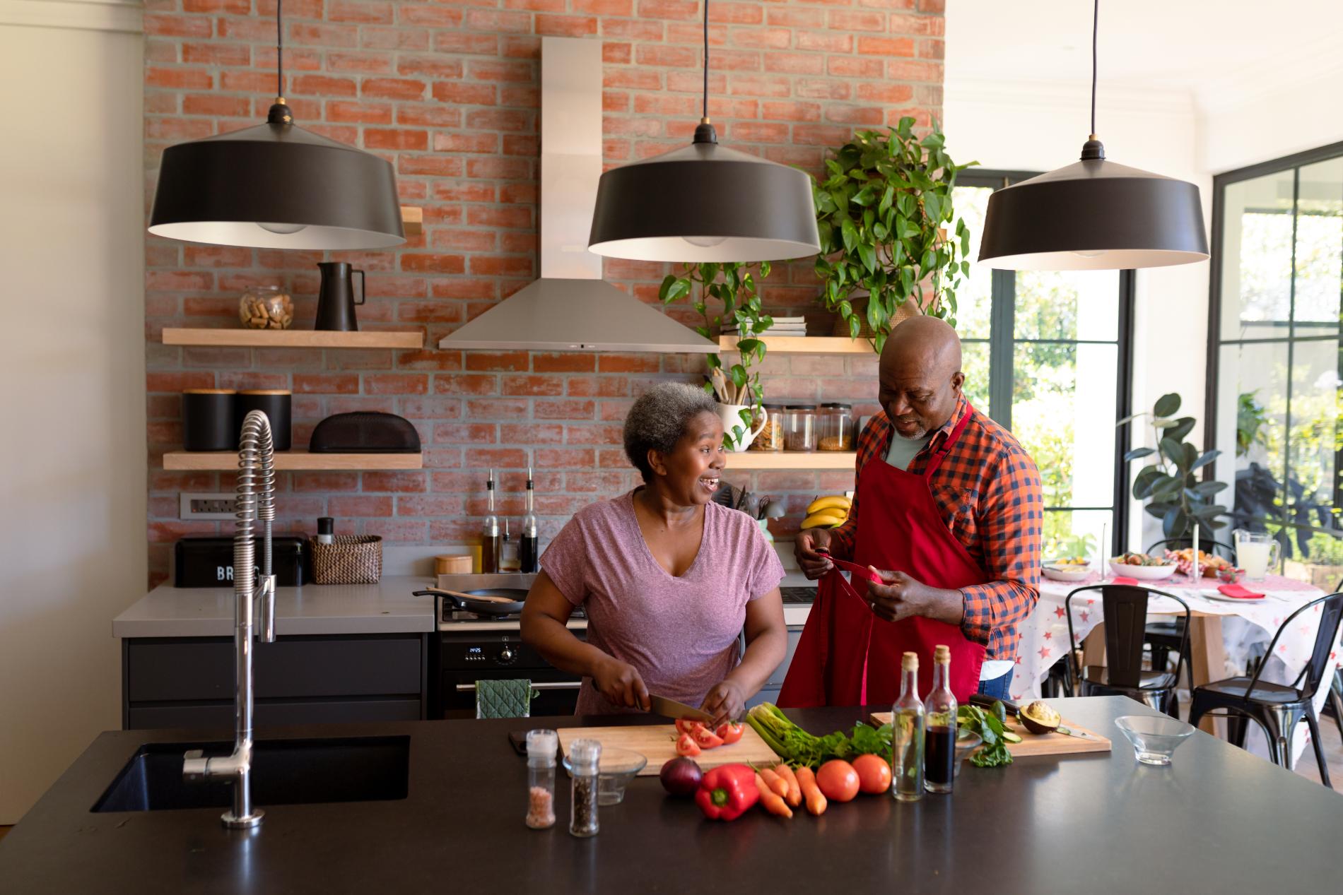happy-african-american-senior-couple-cooking-toget-2023-11-27-05-16-22-utc.jpg