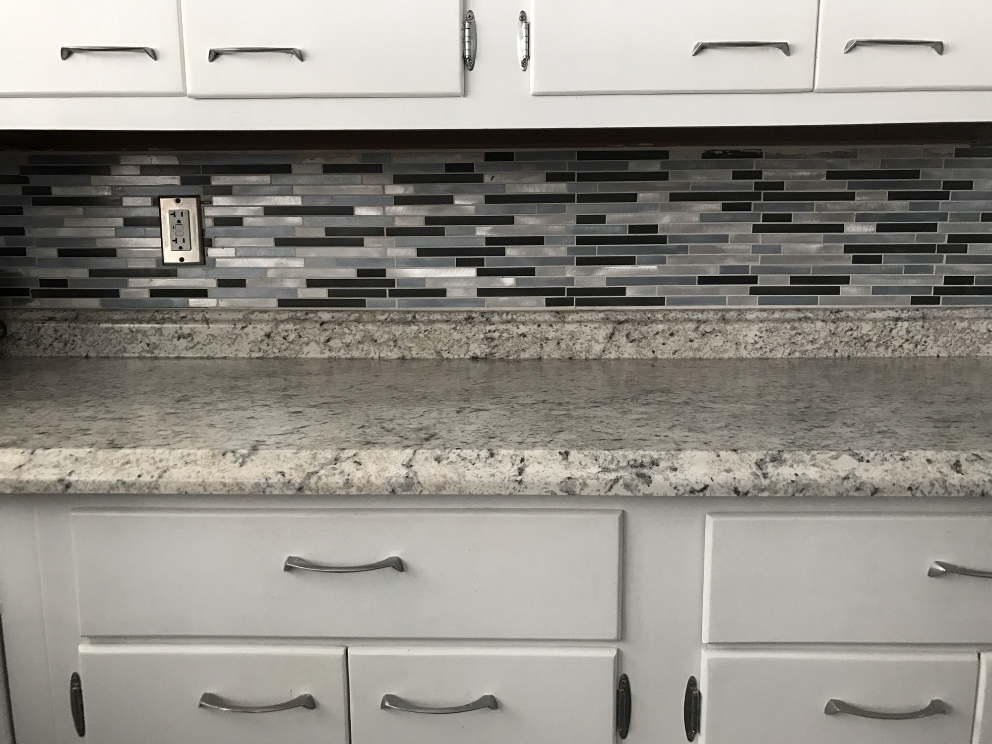 white-cabinets-with-tones-of-blue-backsplash-with-marbling-countertop-interior-renovation.jpg