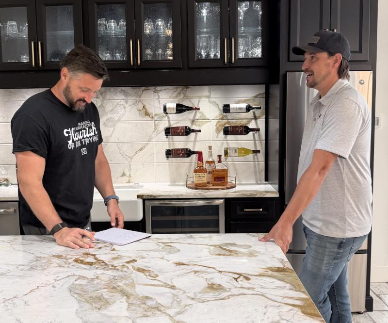 Tim and client discussing by countertop